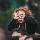 A girl making glasses with her hands.
