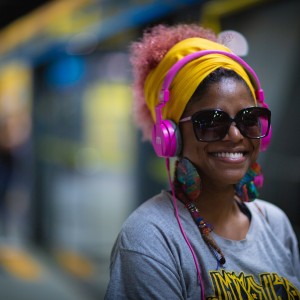 Woman with headphones in a train station.